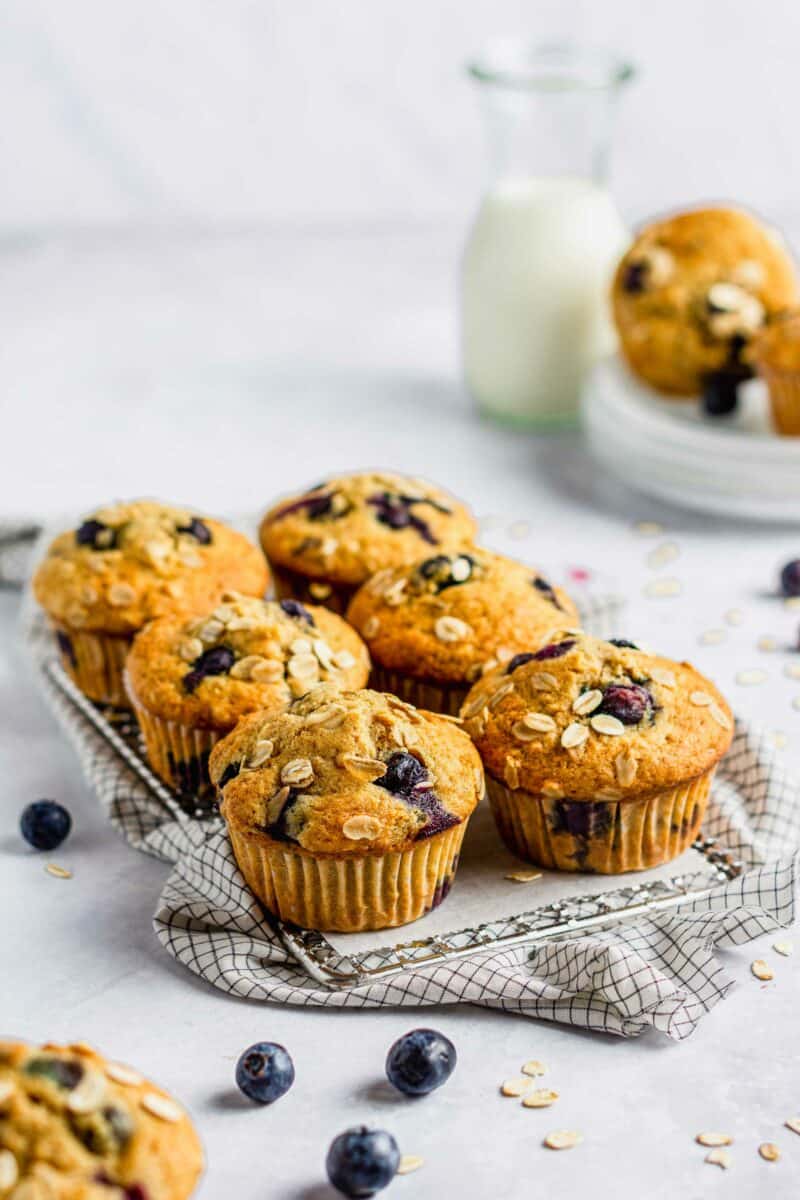 Blueberry oatmeal muffins are baked and presented on a wire cooling rack.