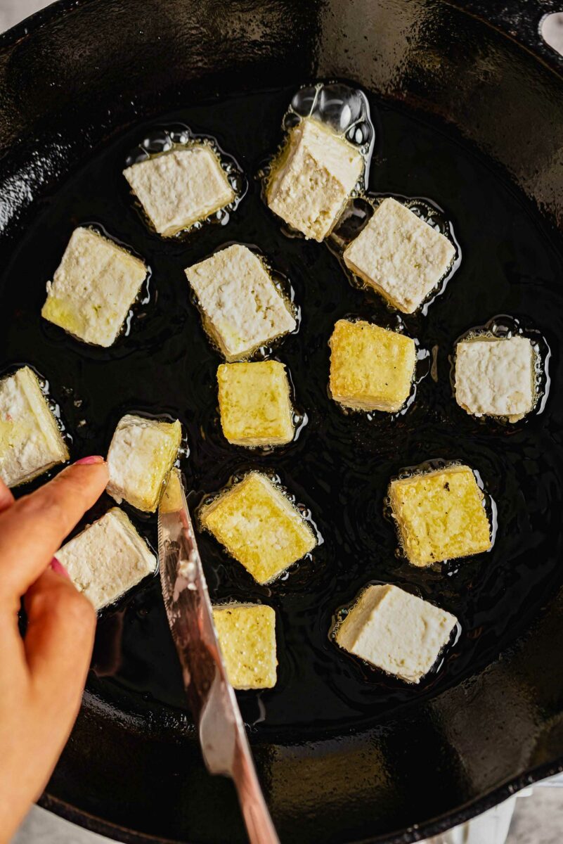 Cubes of tofu cooking in oil