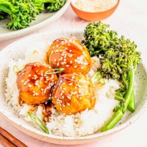Bowl of rice topped with 3 teriyaki tofu meatballs and spears of steamed broccoli