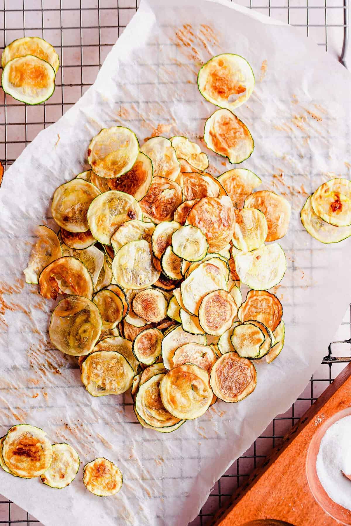 Overhead view of zucchini chips on parchment paper