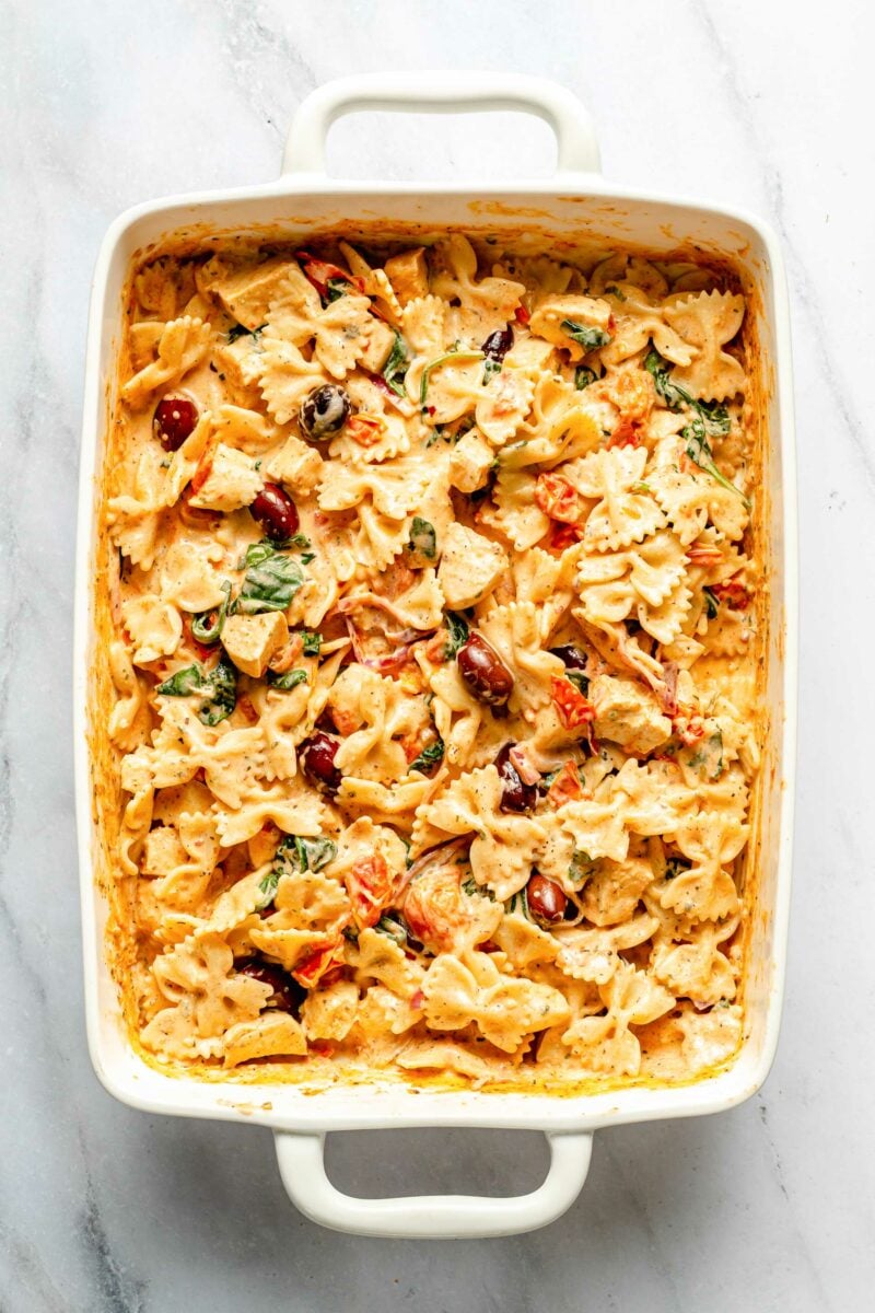 A large white casserole dish is filled with creamy pasta.