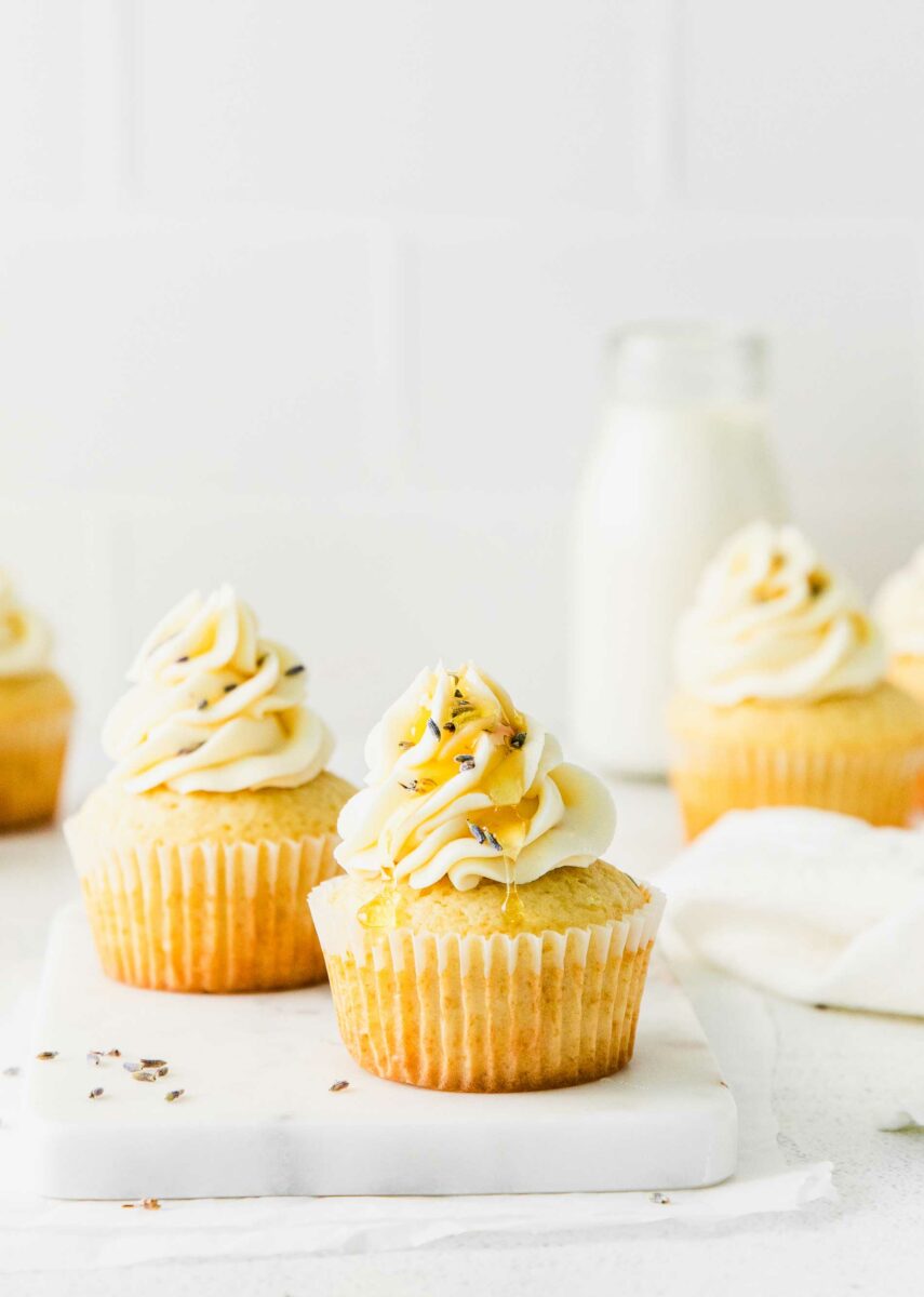 Honey has been drizzled onto a frosted cupcake. 