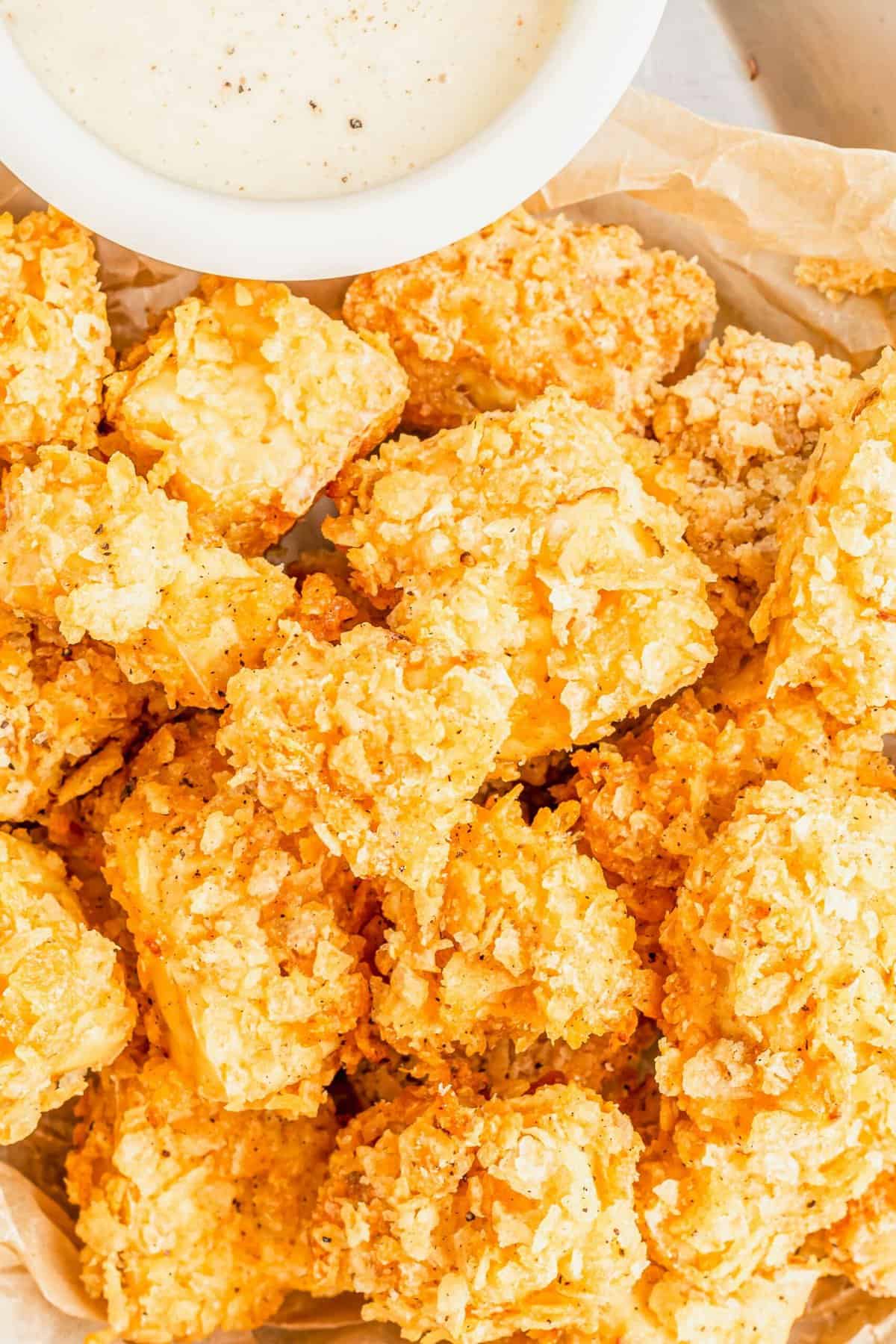 Pile of crispy popcorn tofu with dipping sauce