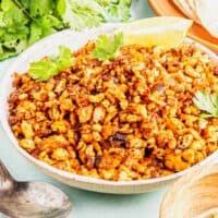 Bowl of tofu chorizo with cilantro leaves and lime wedge