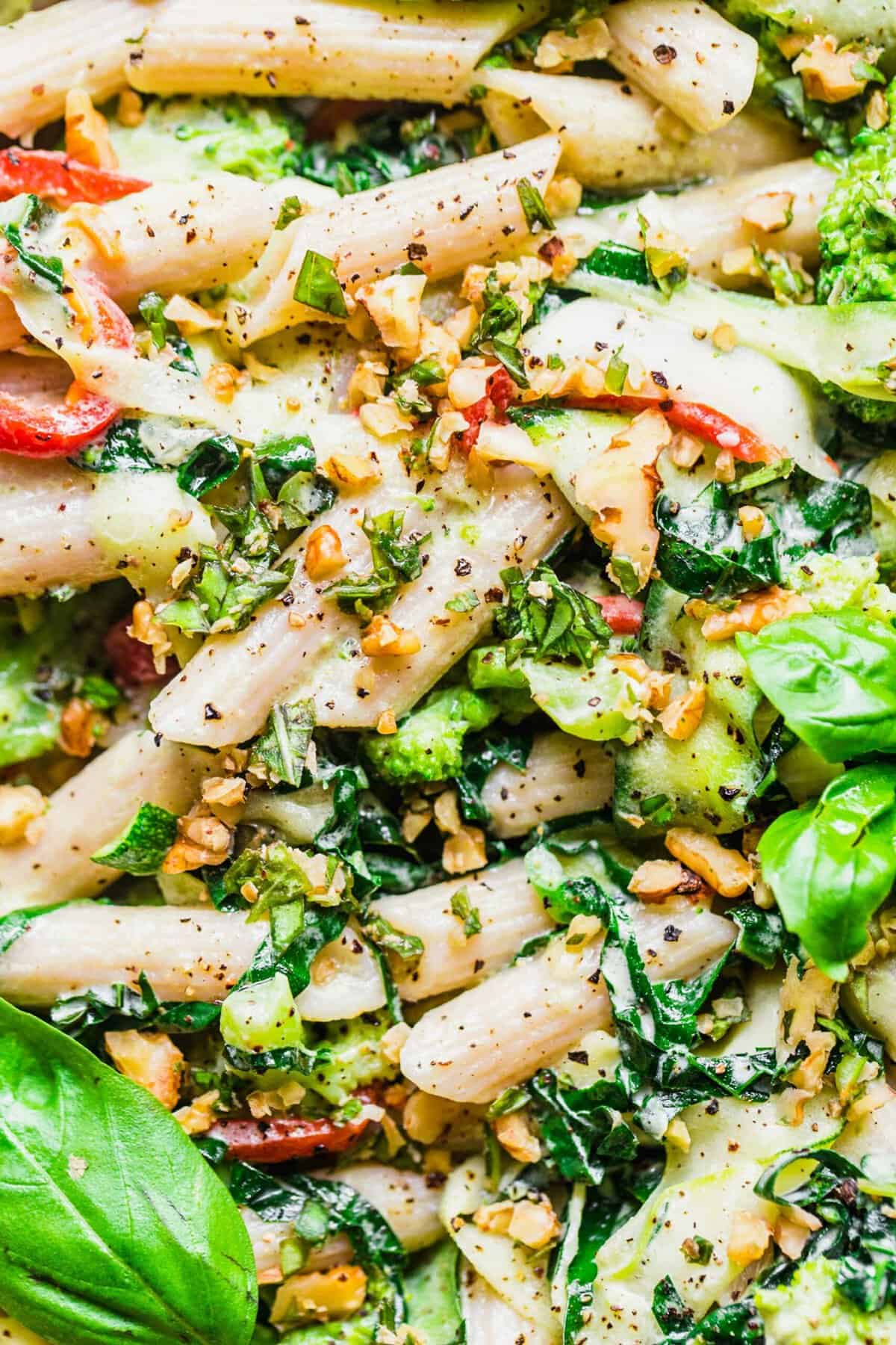 Freshly made pasta and veggies are topped with a generous amount of black pepper. 