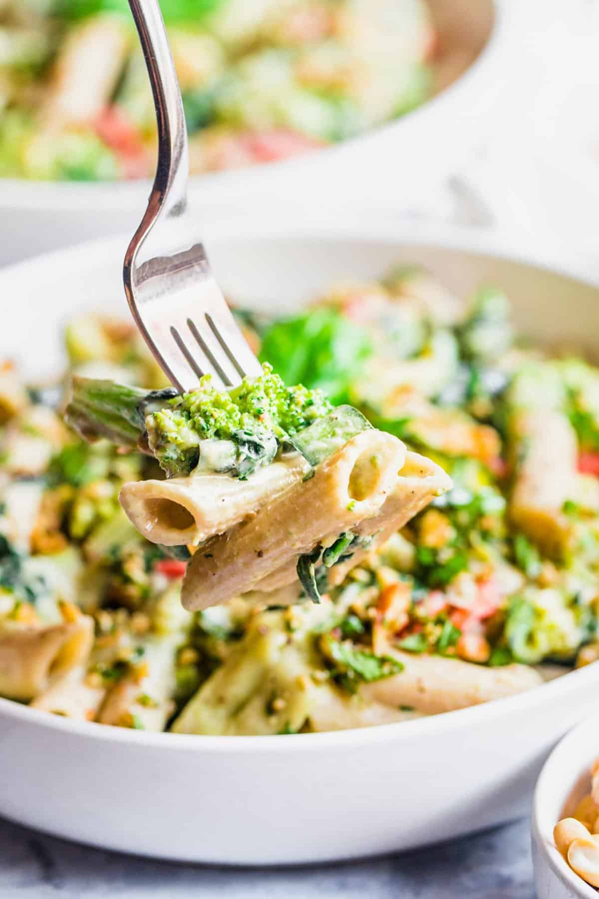 A forkful of pasta is being lifted from the bowl. 