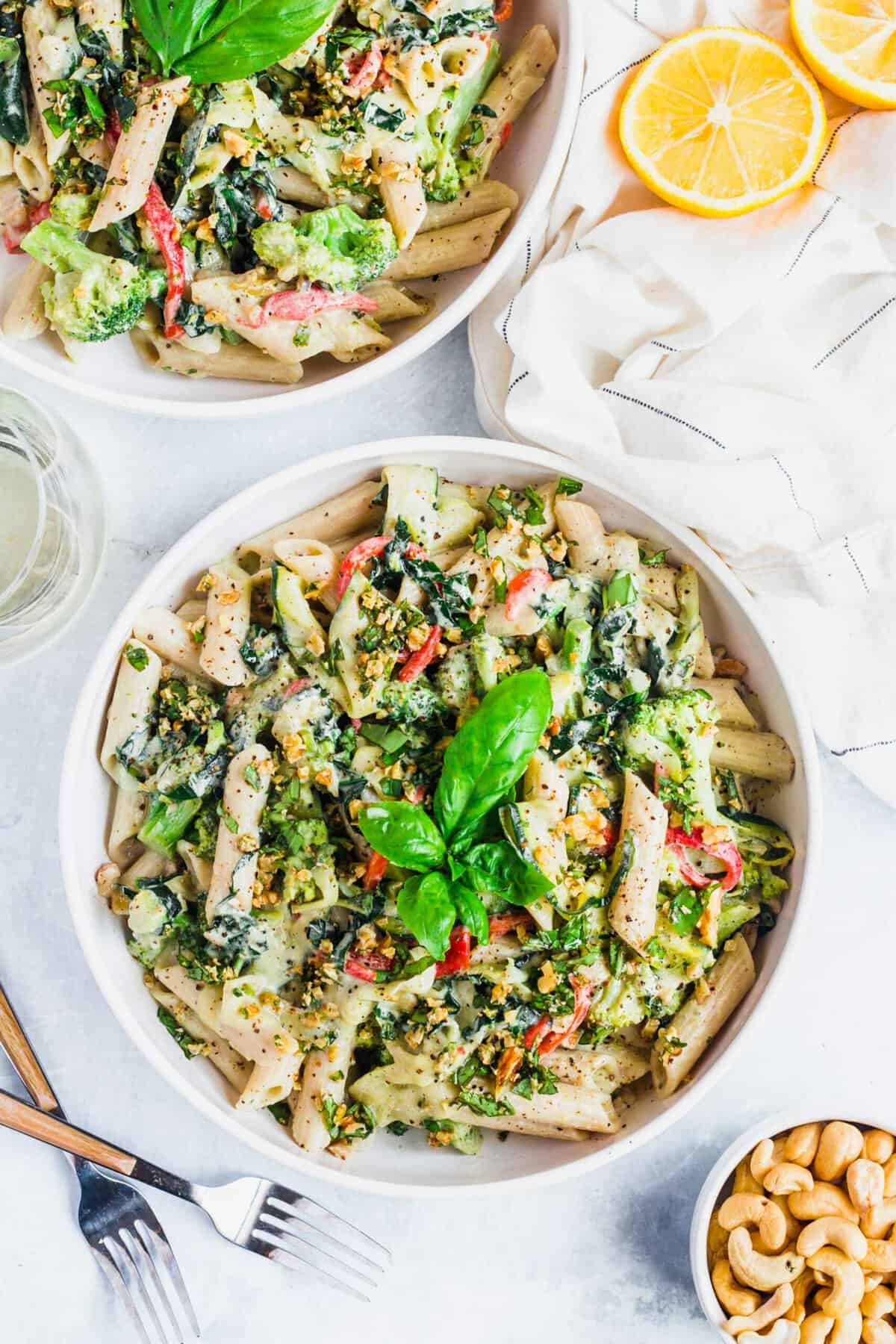 A few fresh basil leaves garnish a bowl of pasta. 