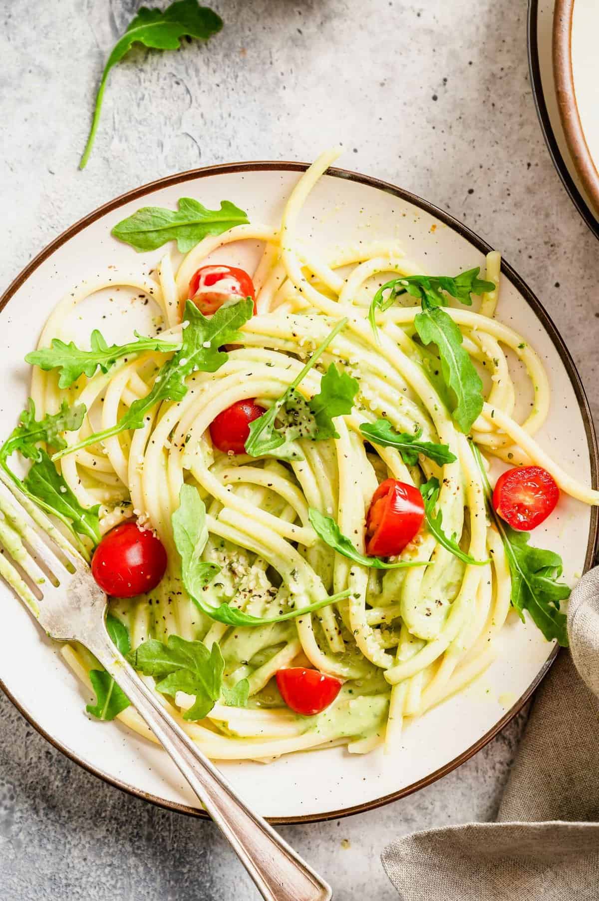 Plate of creamy avocado pasta with fork