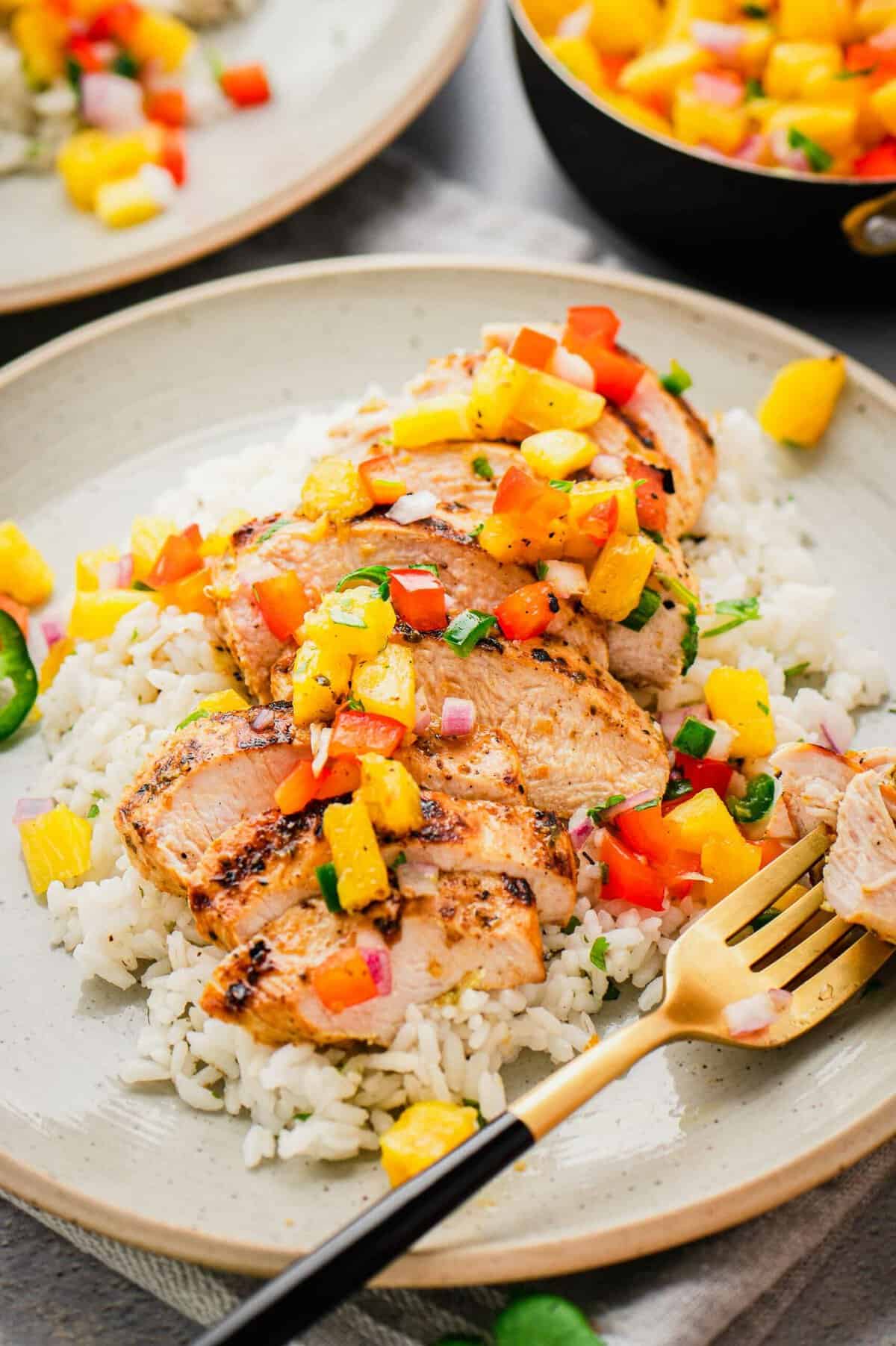 Grilled mojo chicken on plate with rice and pineapple salsa