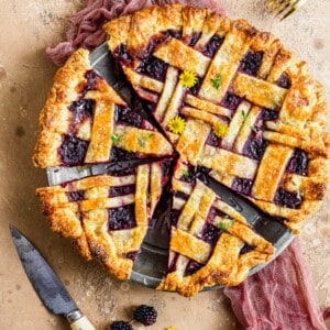 Overhead view of honey thyme blackberry pie cut in pie plate