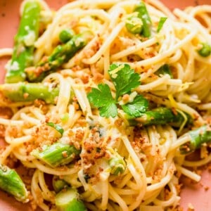 Asparagus and lemon pasta on plate garnished with herbs and breadcrumbs