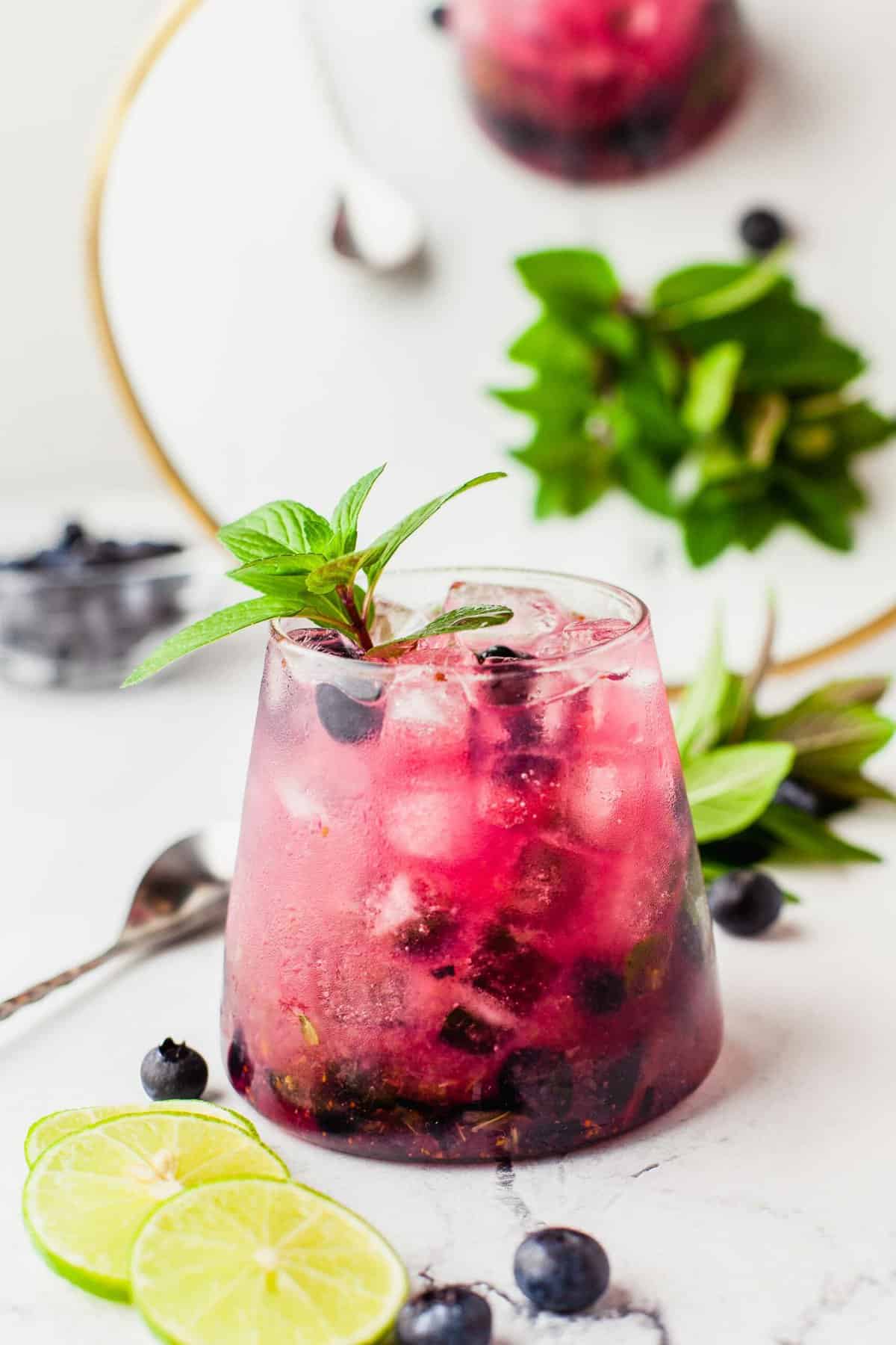 Blueberry mojito garnished with sprig of mint leaves