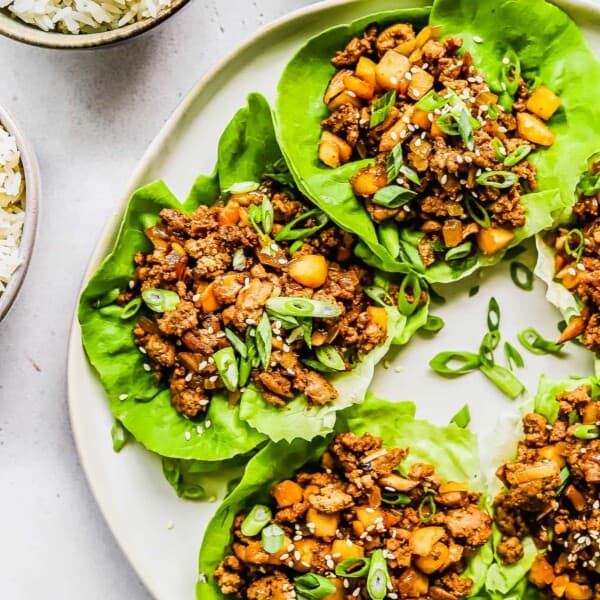 Plate of lettuce wraps with ground chicken, mushrooms, and water chestnuts.