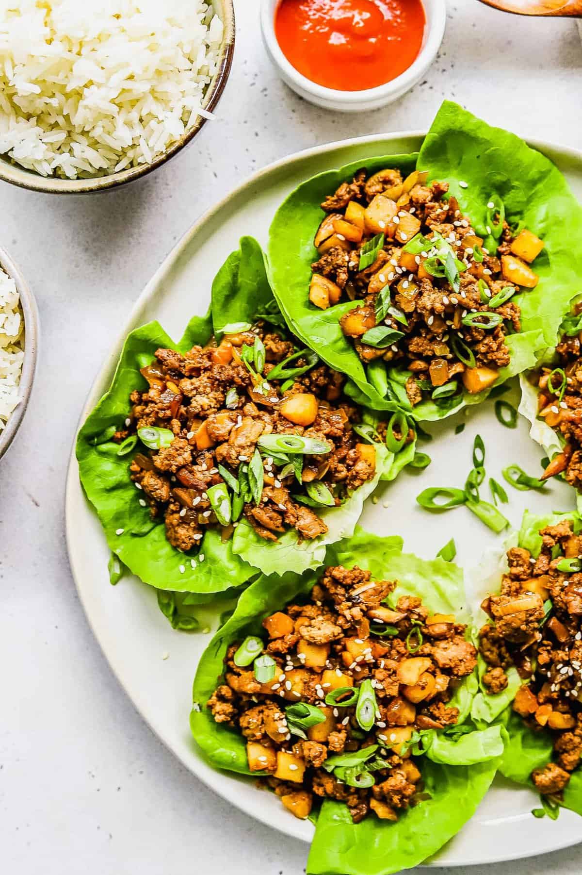 Plate of lettuce wraps with ground chicken, mushrooms, and water chestnuts.