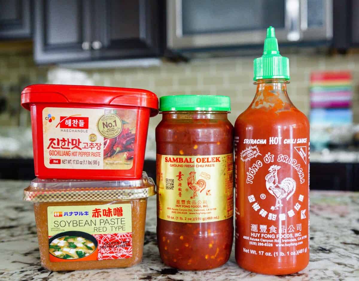 photo of gochujang, miso paste, sambal oelek, and sriracha