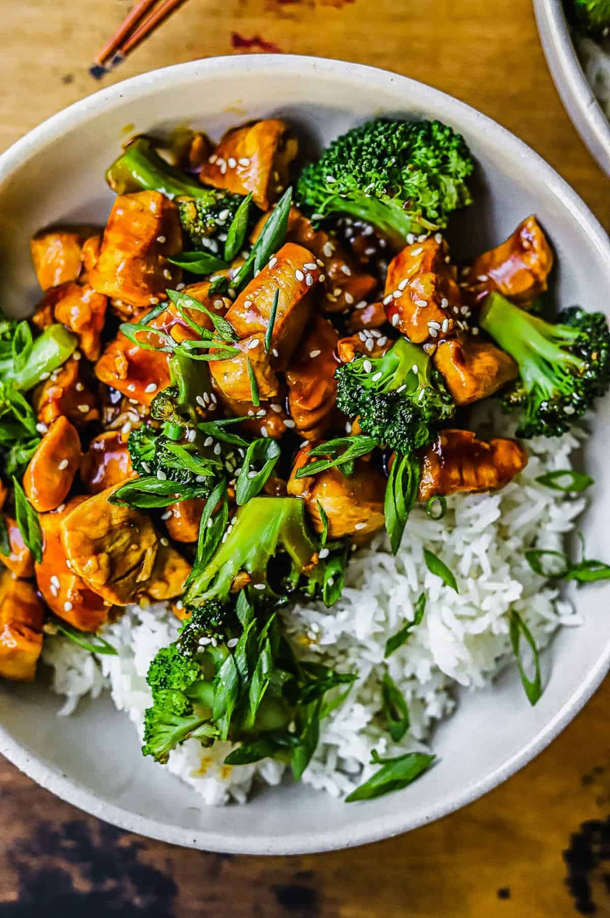 overhead shot showing the teriyaki chicken and broccoli with rice sprinkled with green onions and sesame seeds