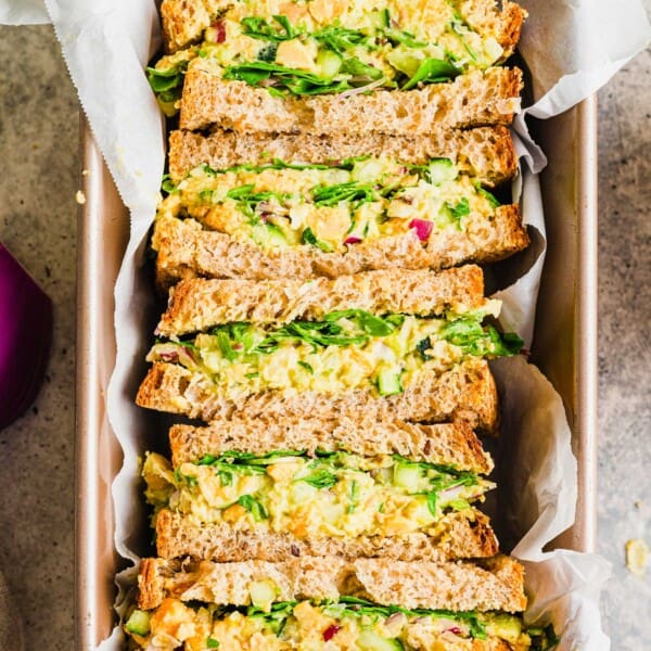 5 halved smashed chickpea sandwiches arranged in loaf pan