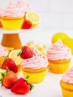 Strawberry lemonade cupcakes on table and cake stand