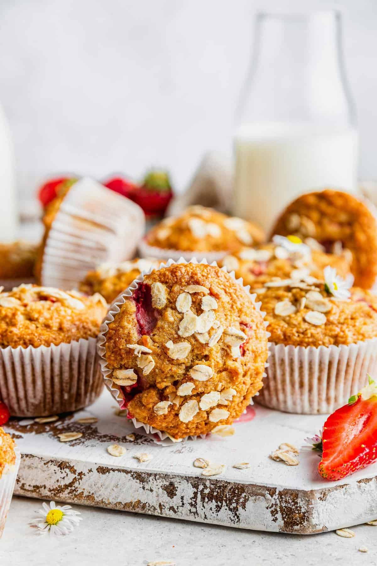 Strawberry muffins on rustic wood board