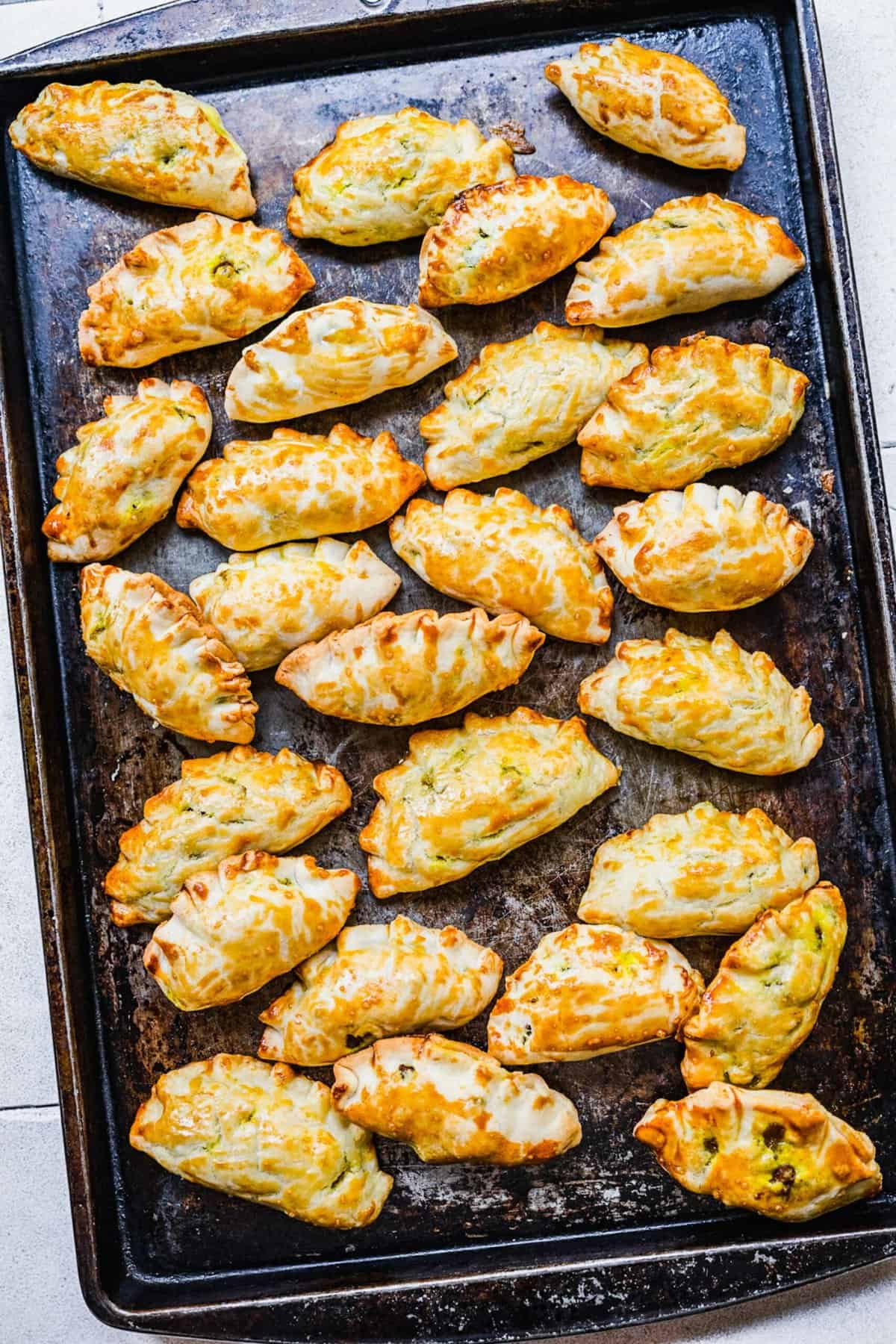 Overhead view of Chinese curry pockets on sheet pan