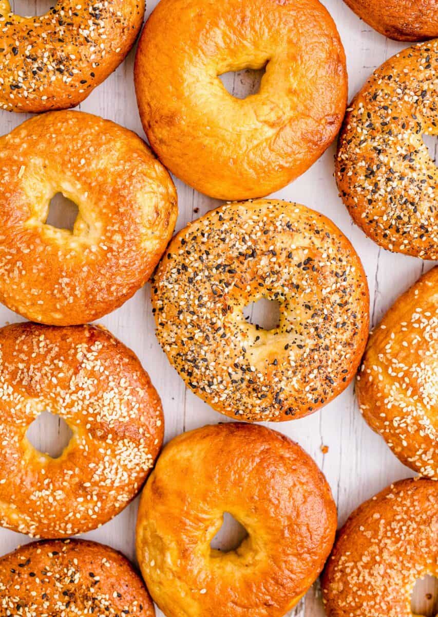 Multiple bagels are placed on a white countertop. 