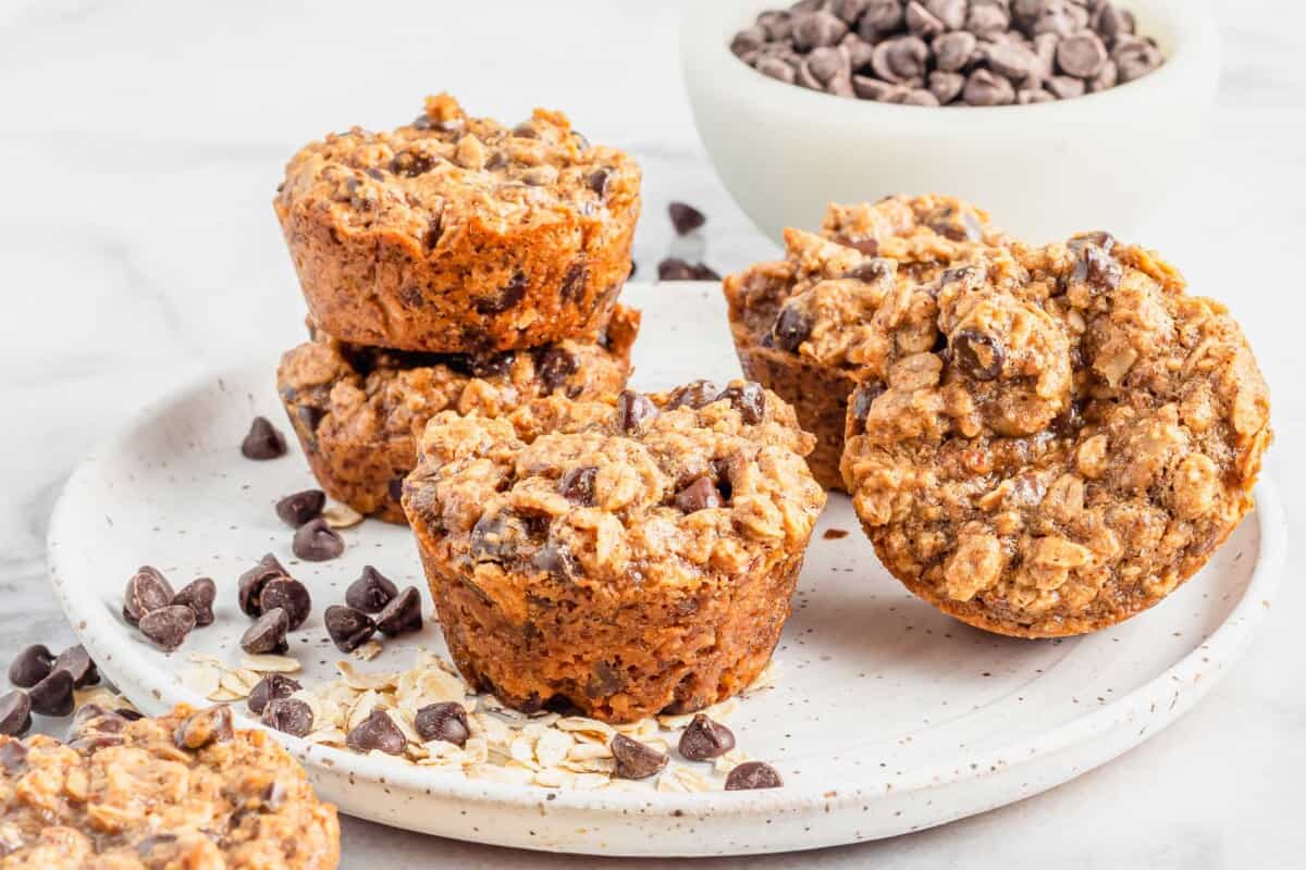 A round white plate is topped with several cookie cups.