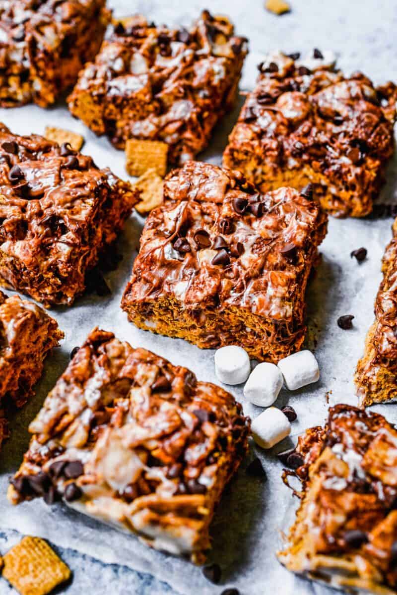 Marshmallows and chocolate chips are scattered around sliced bars. 