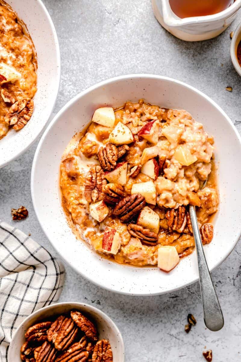 apple cinnamon oats in white bowl with spoon