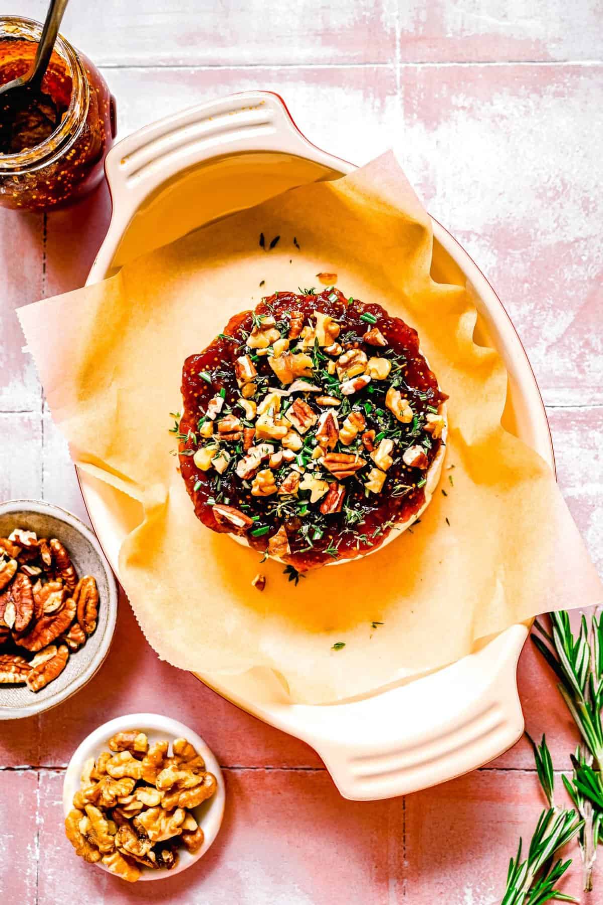 overhead image of assembled baked brie in a baking dish