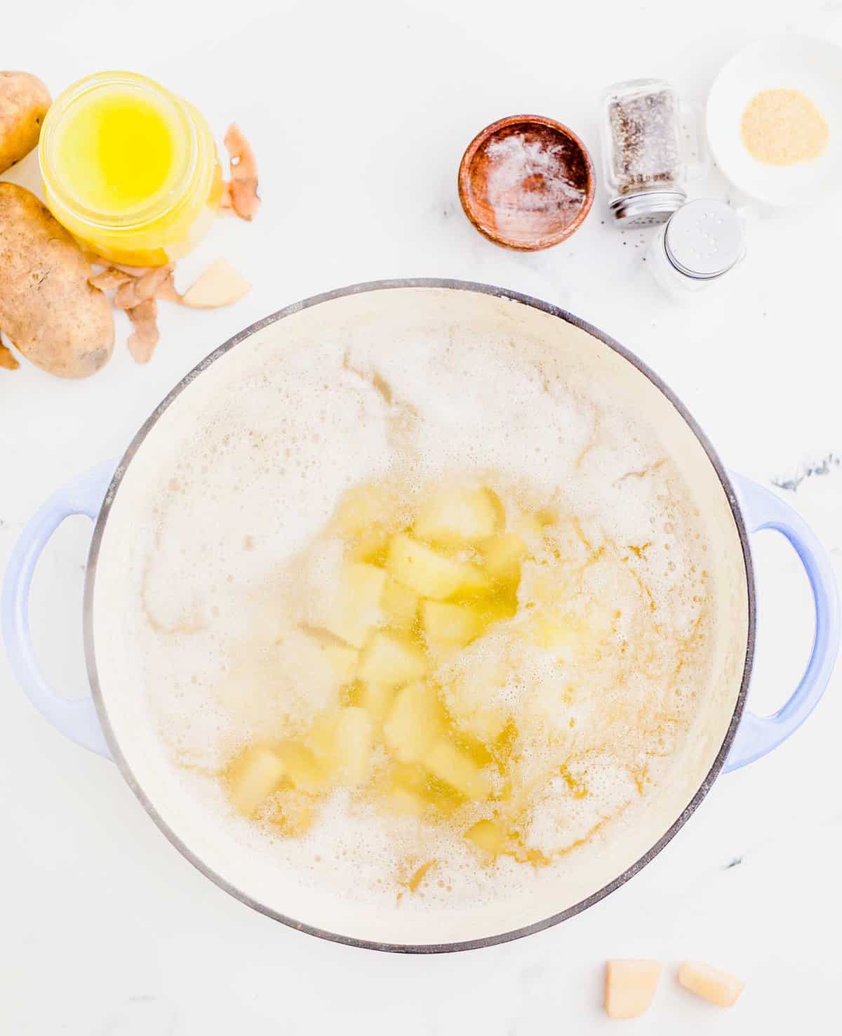 image of potatoes in a large pot of boiling water being parboiled