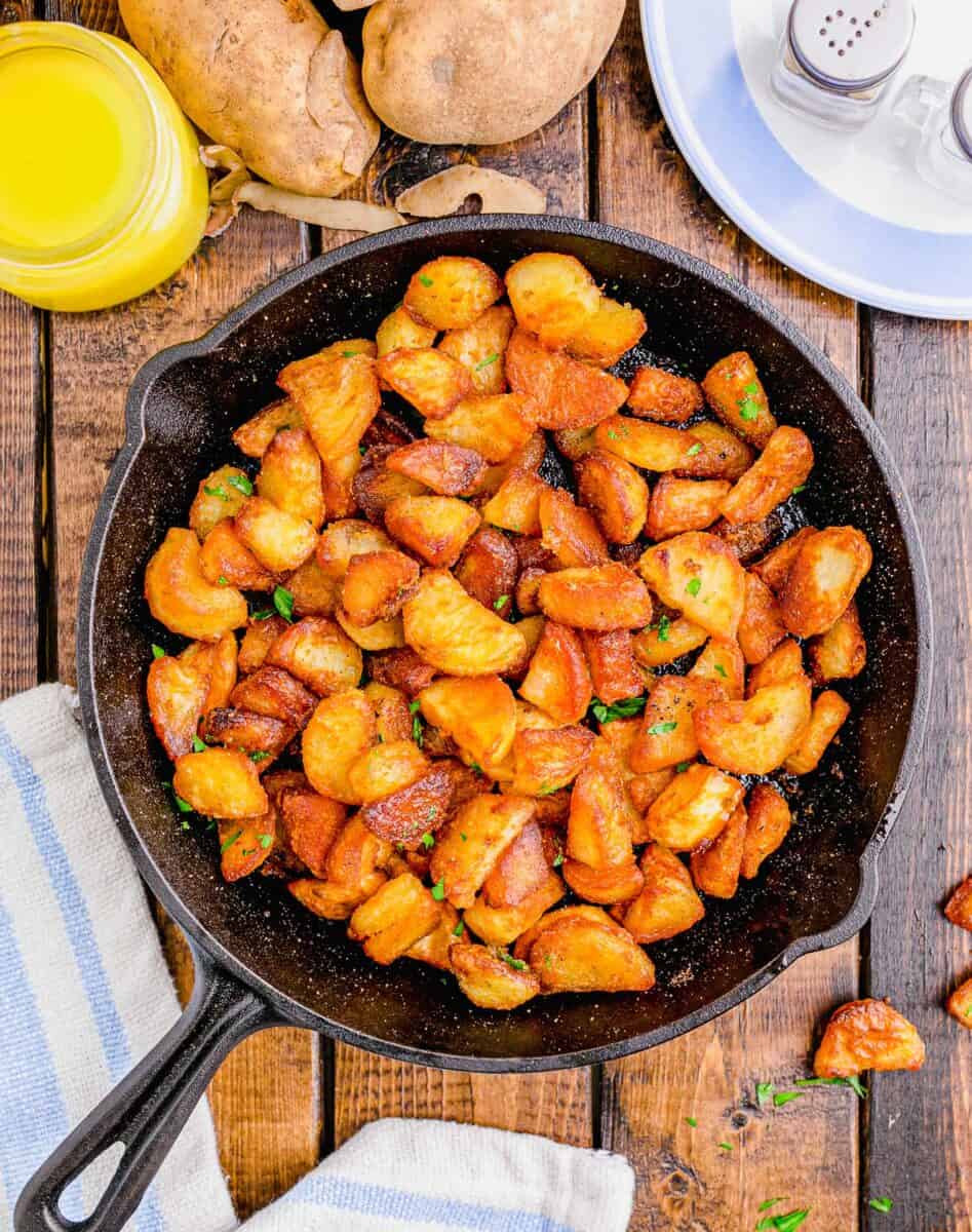 overhead shot of finished duck fat potatoes in a cast iron skillet