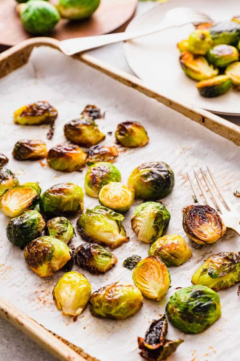 roasted brussels sprouts on a rimmed baking sheet