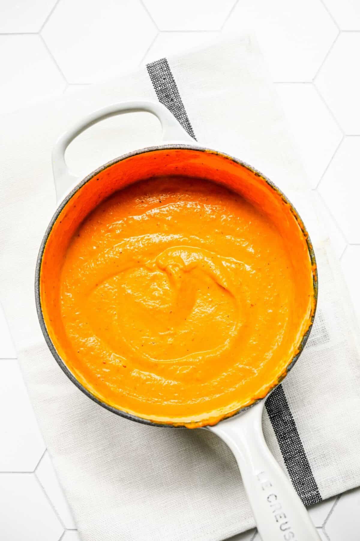 A saucepan filled with pumpkin cream sauce