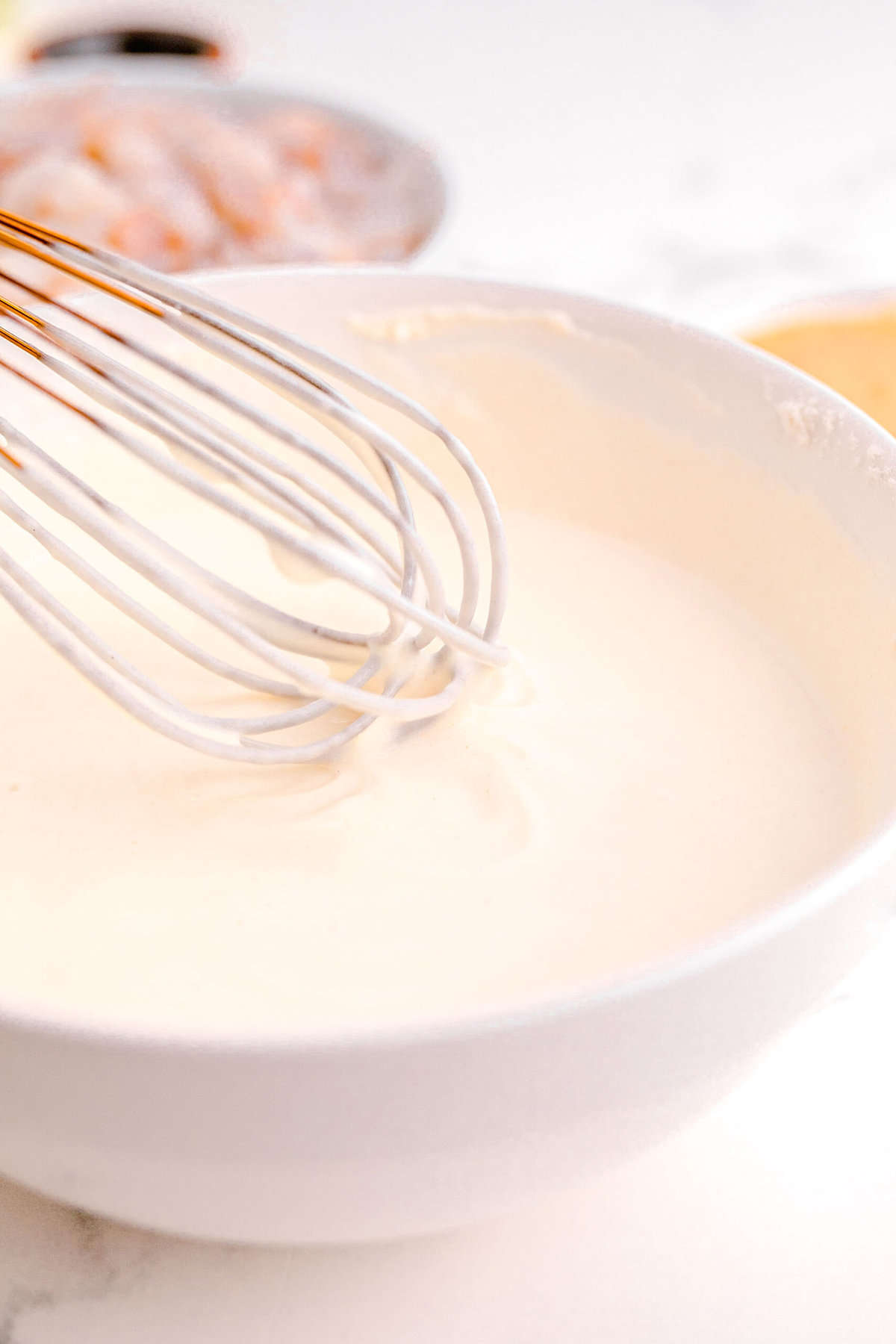 buttermilk, cornstarch, and flour mixture being whisked together in a white bowl