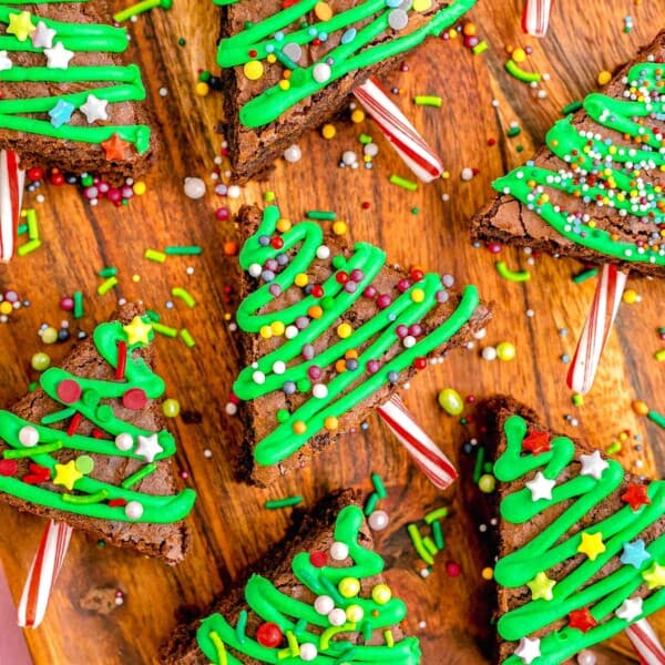 christmas tree brownies with round sprinkles on a wooden background