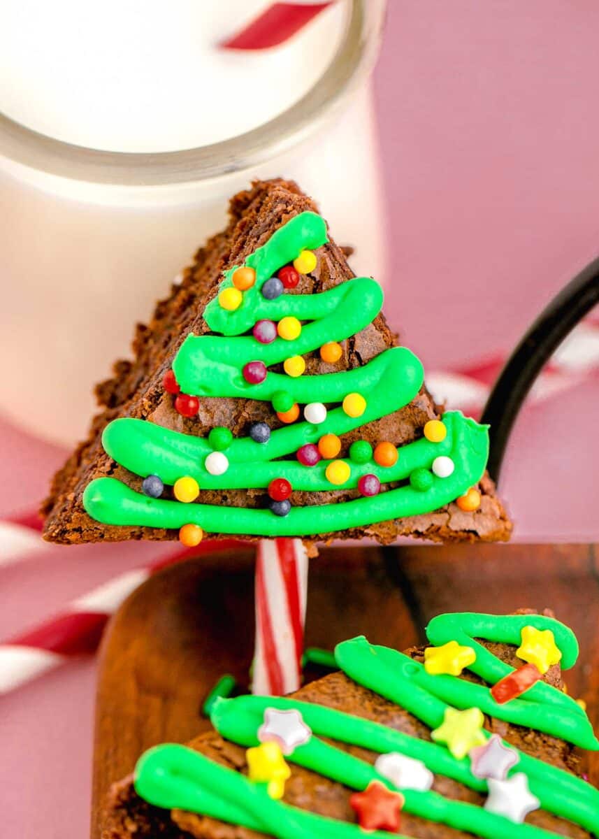 up close image of christmas tree brownies with green frosting piping and colorful sprinkles