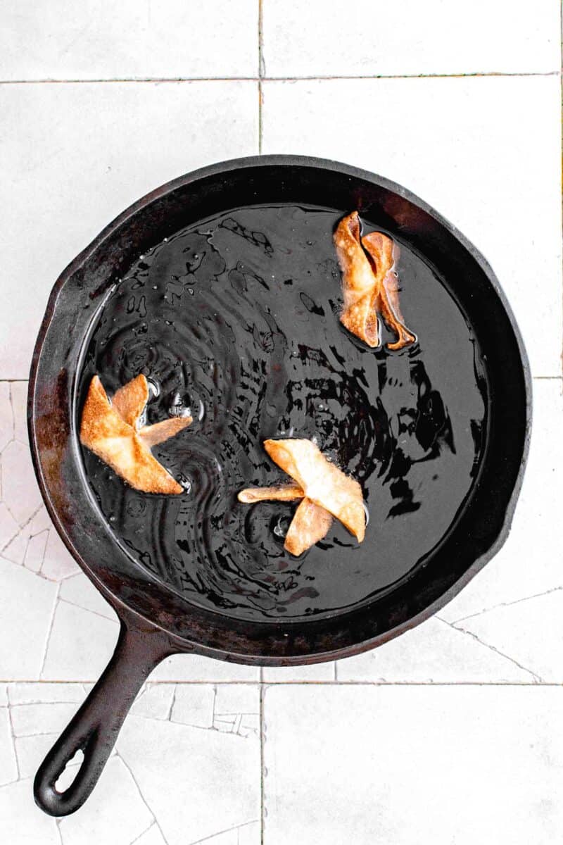shallow frying the crab rangoon in a cast iron skillet