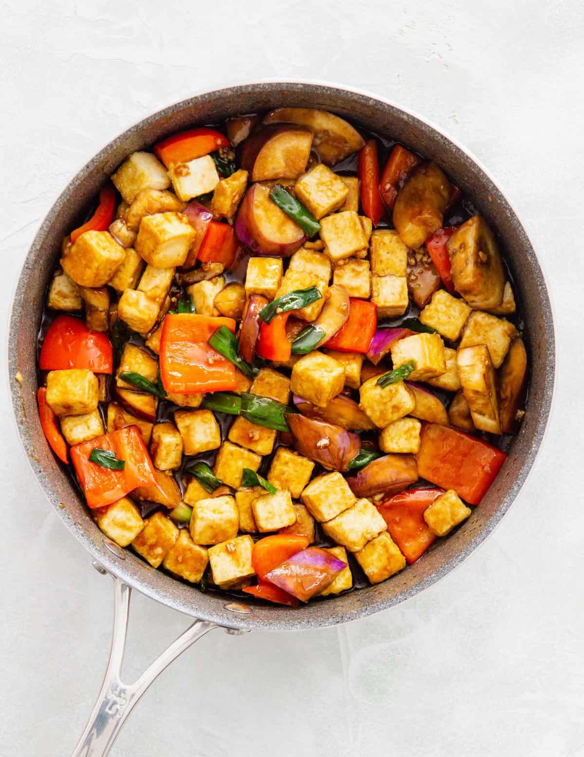 sauce added into the tofu and eggplant mixture in the skillet