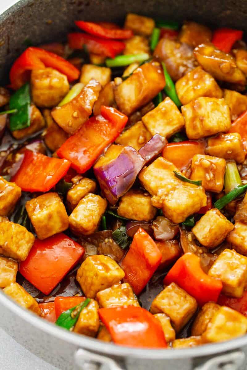 up close image of eggplant tofu recipe in the skillet with brown sauce