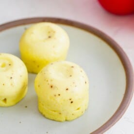 instant pot egg bites with black pepper speckles on a ceramic plate