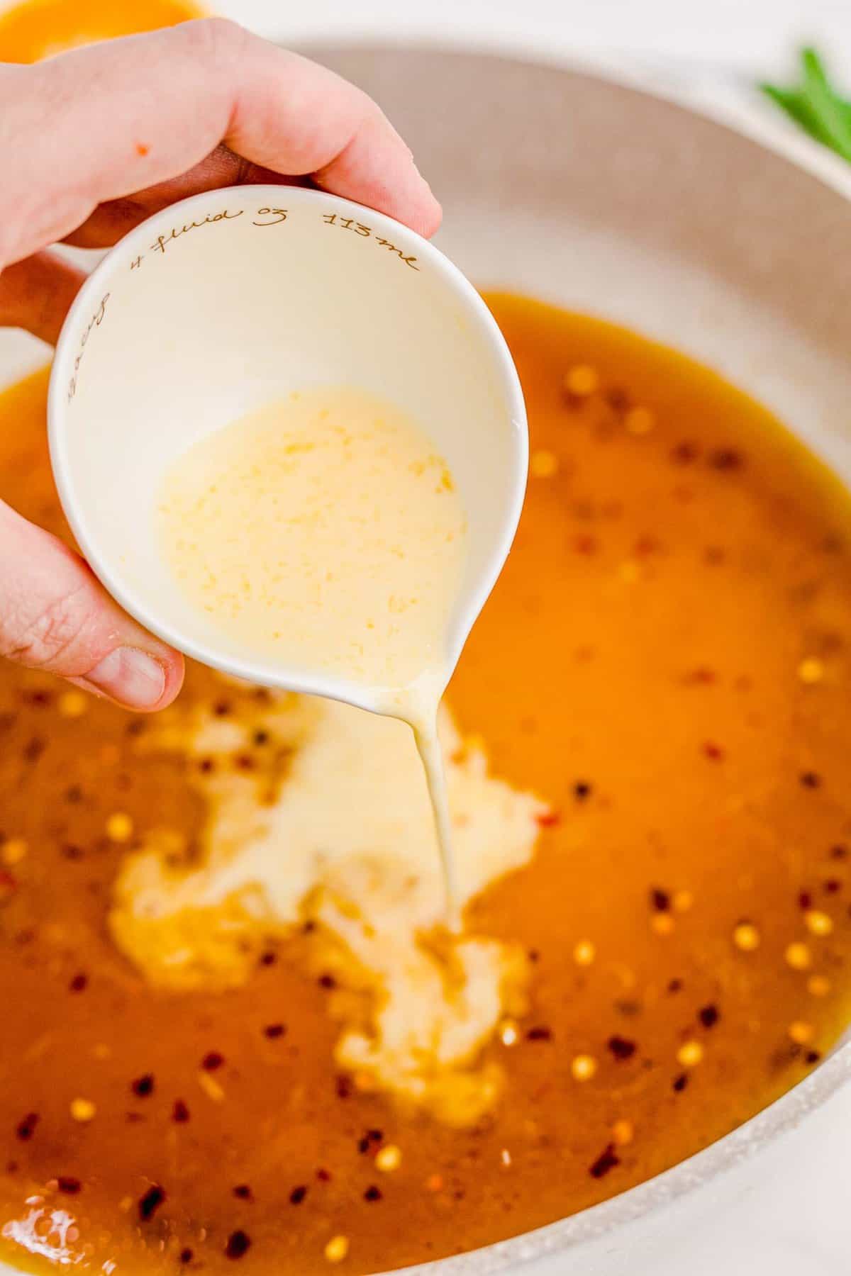 Mixing the orange juice cornstarch mixture into the sauce