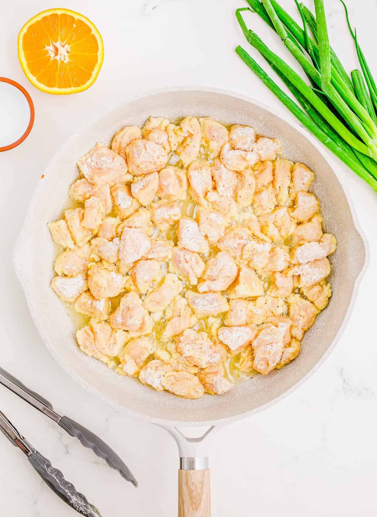 Frying breaded chicken bites in a skillet