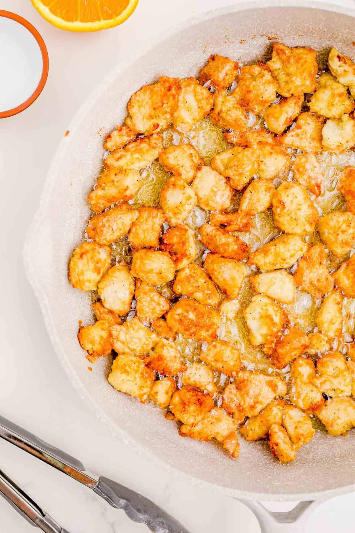 Fried chicken bites in a skillet