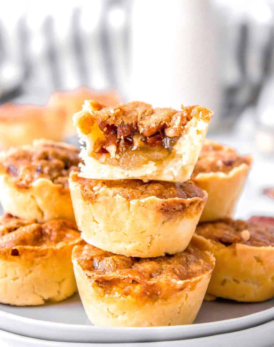 pecan tassie bitten in half to show the gooey inside