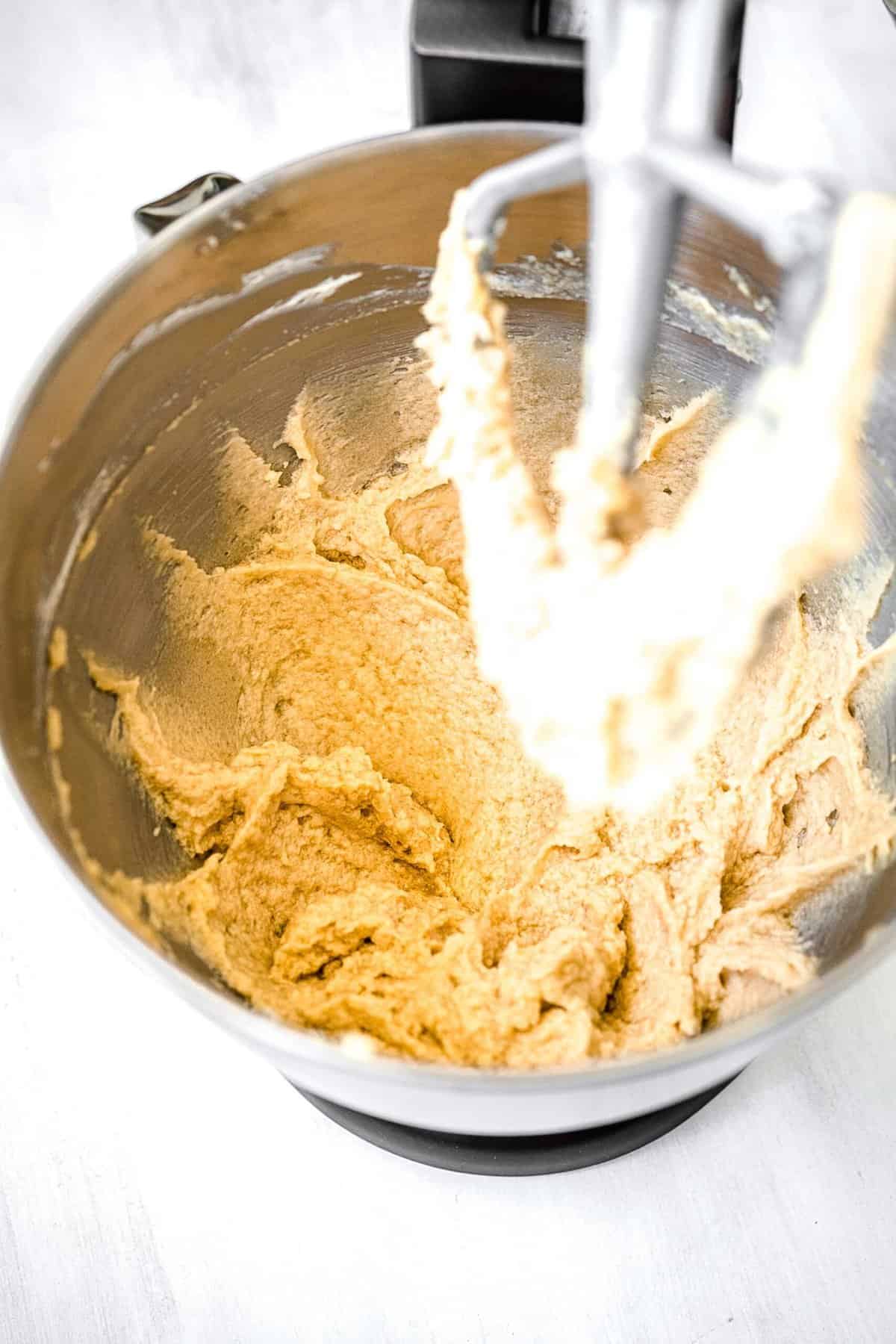 creaming together butter and sugars with the paddle attachment of a stand mixer