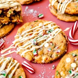 peppermint white chocolate cookie with white chocolate drizzle and crushed candy canes on top