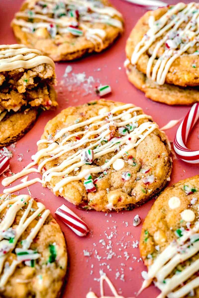 peppermint white chocolate cookie with white chocolate drizzle and crushed candy canes on top