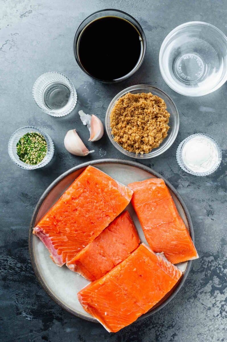 ingredients for air fryer teriyaki salmon: soy sauce, water, brown sugar, cornstarch, garlic, rice vinegar, salmon, and furiyaki