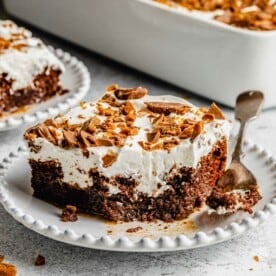 Better than Sex Chocolate Cake sliced and served on plates with a fork.