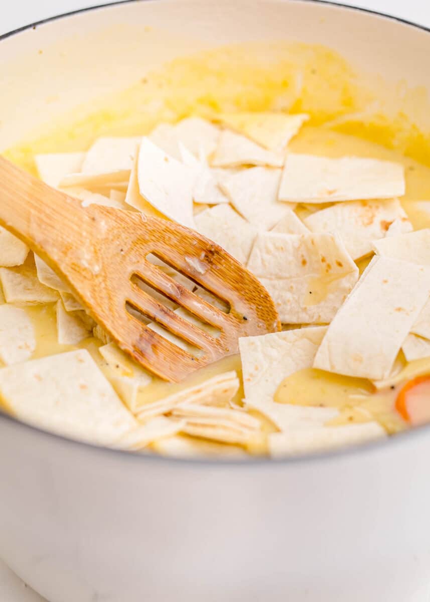 gently pressing down on the flour tortillas